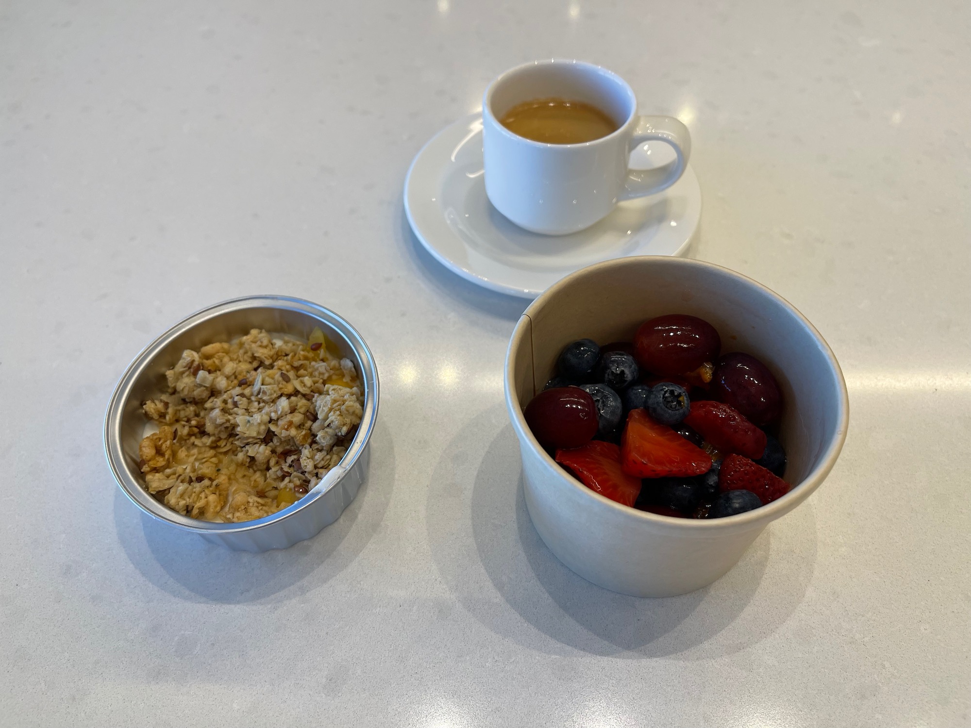 a bowl of fruit and a cup of coffee