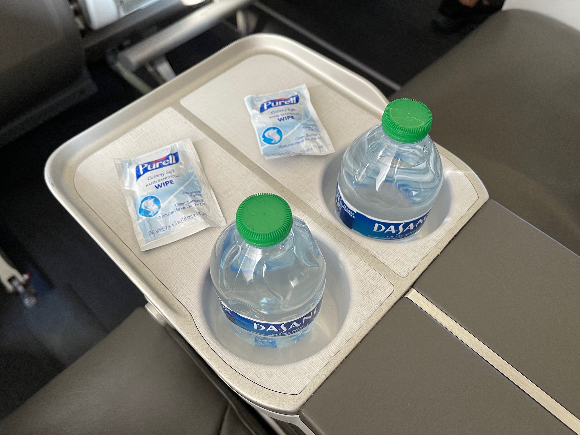 a tray with two bottles and wipes on it