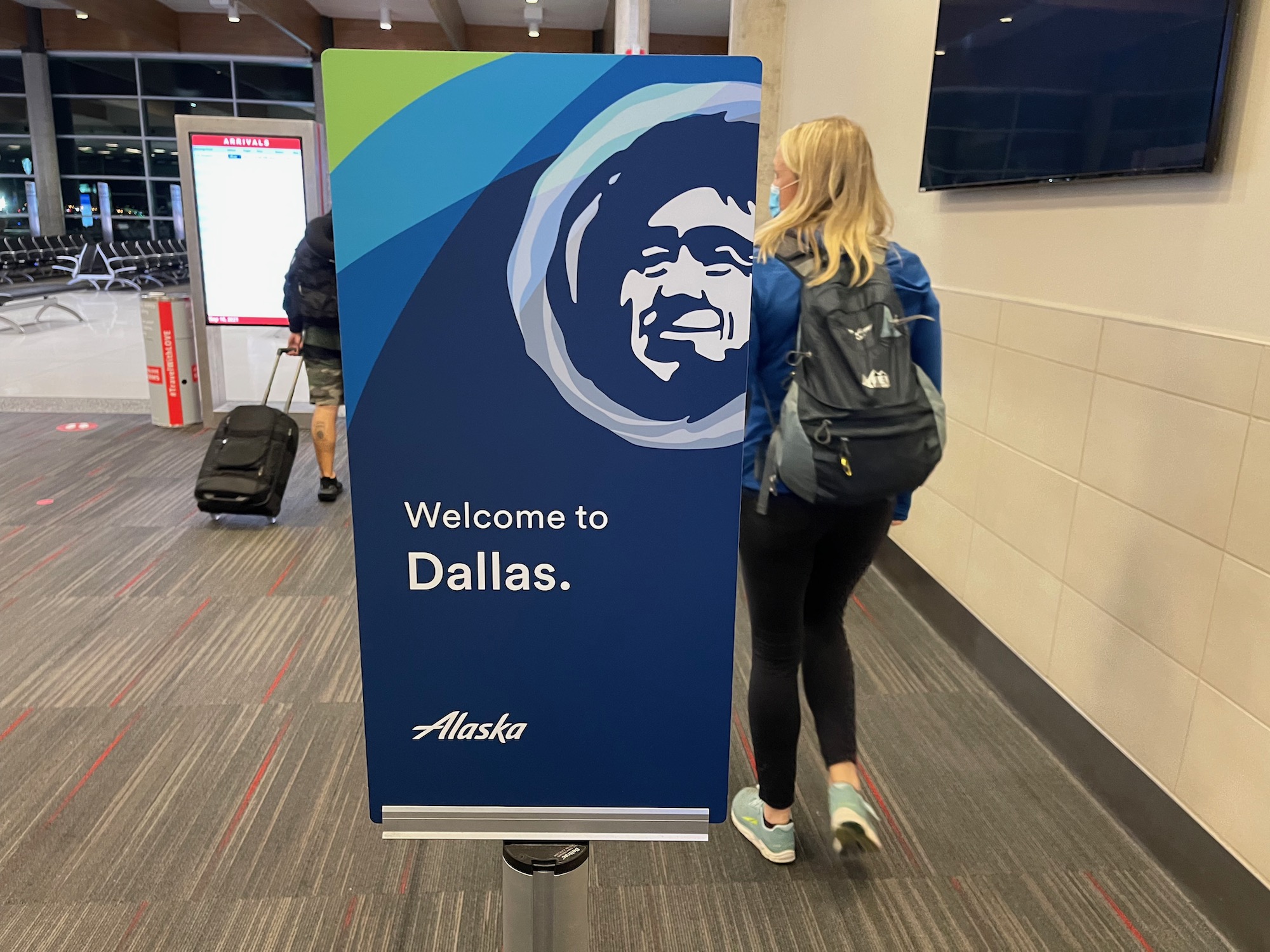 a woman standing next to a sign