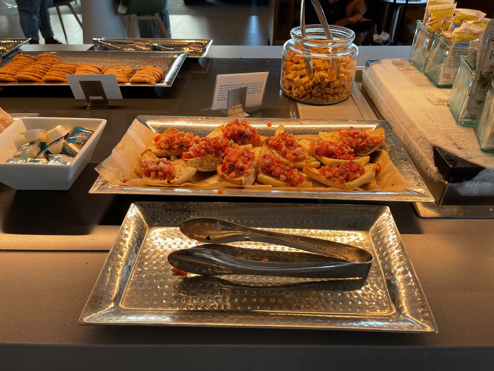 food on a tray with tongs