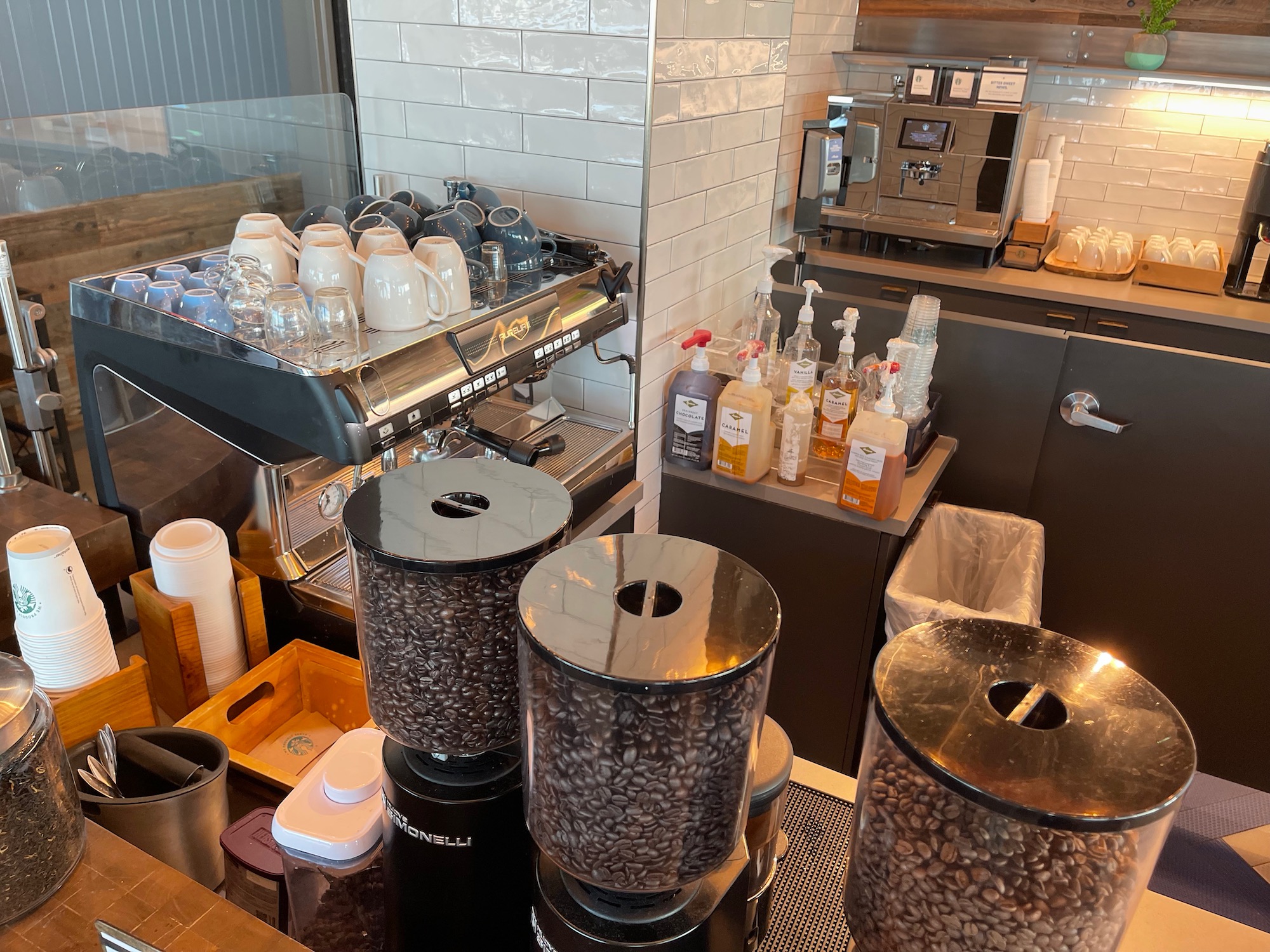 a coffee machine with coffee beans and cups