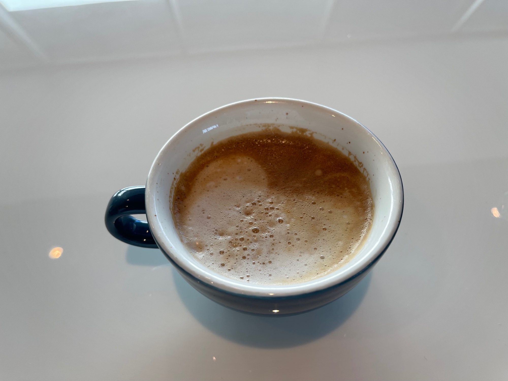 a cup of coffee on a white surface