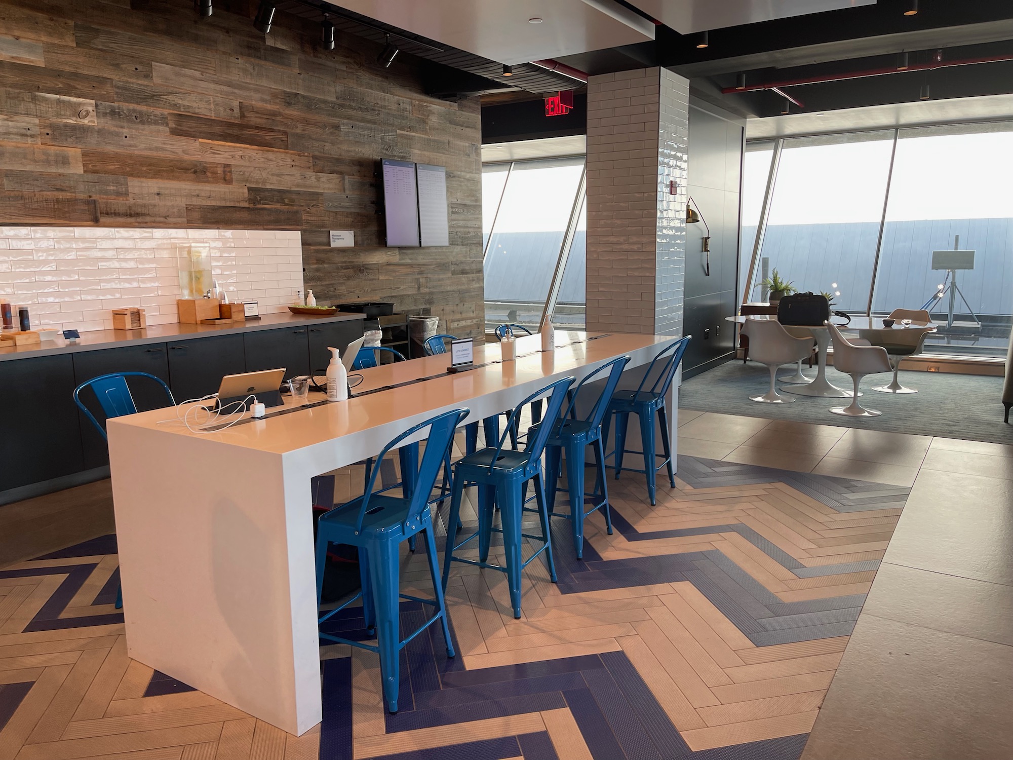 a room with a long table and blue chairs