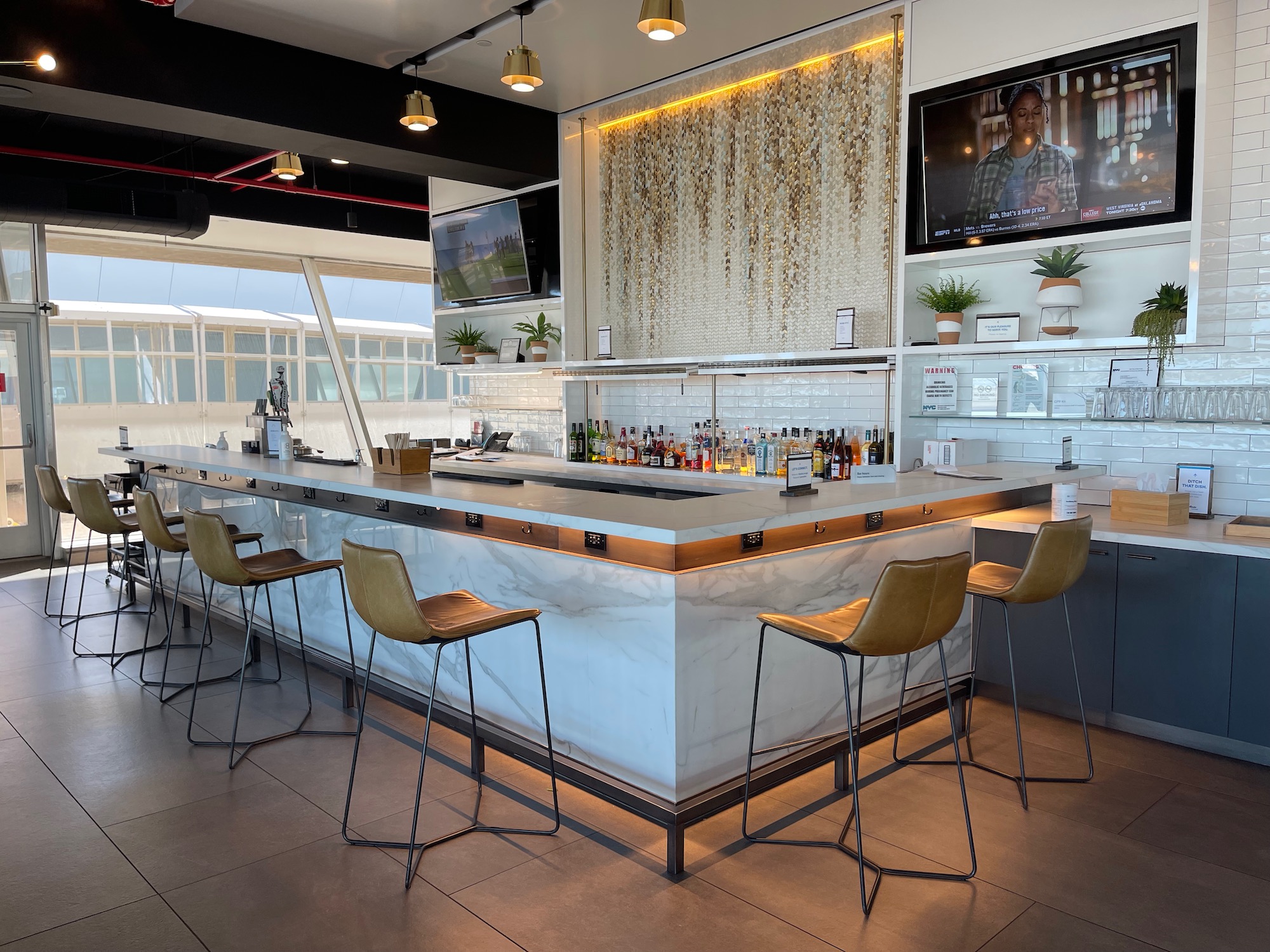 a bar with a counter and chairs