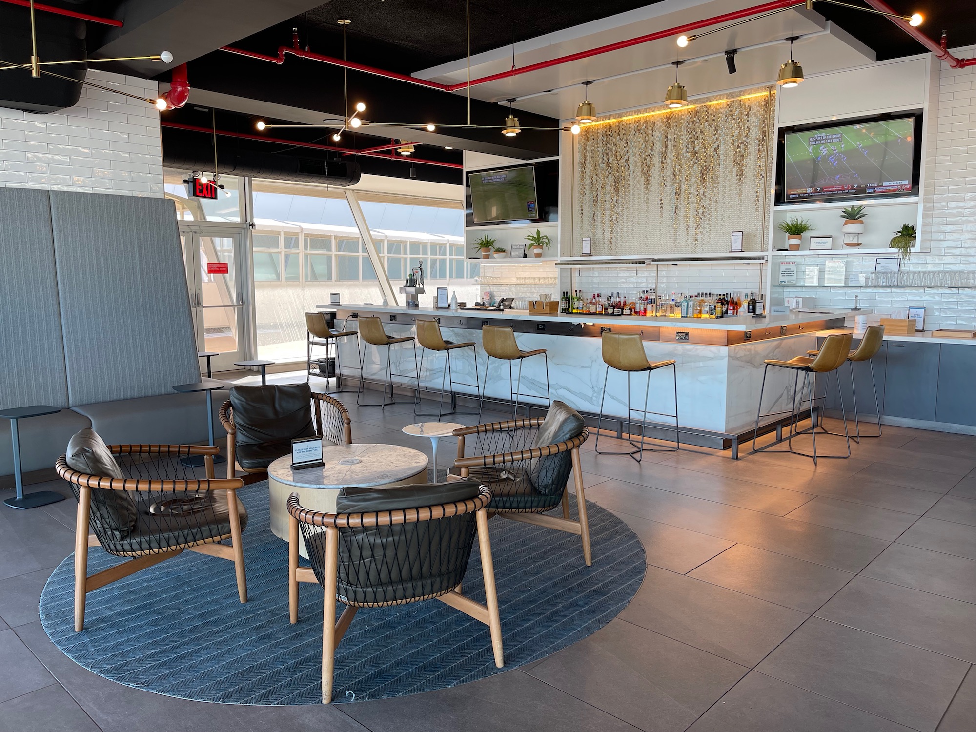 a room with a bar and chairs