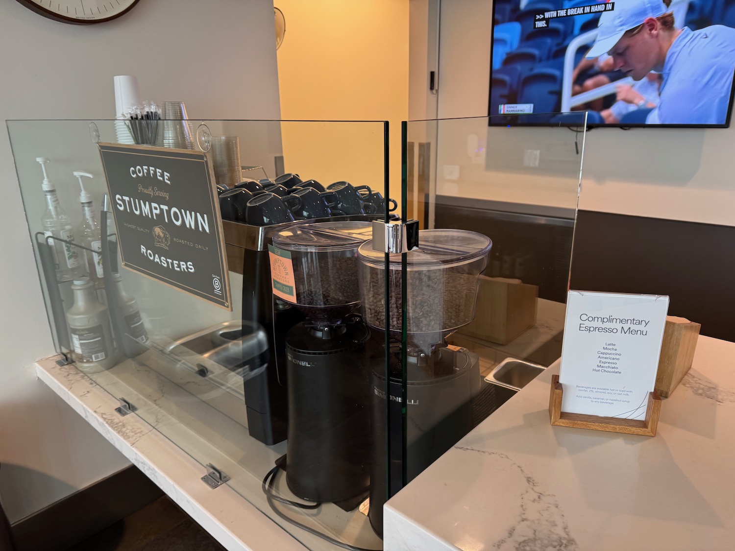 a glass case with a display of coffee equipment