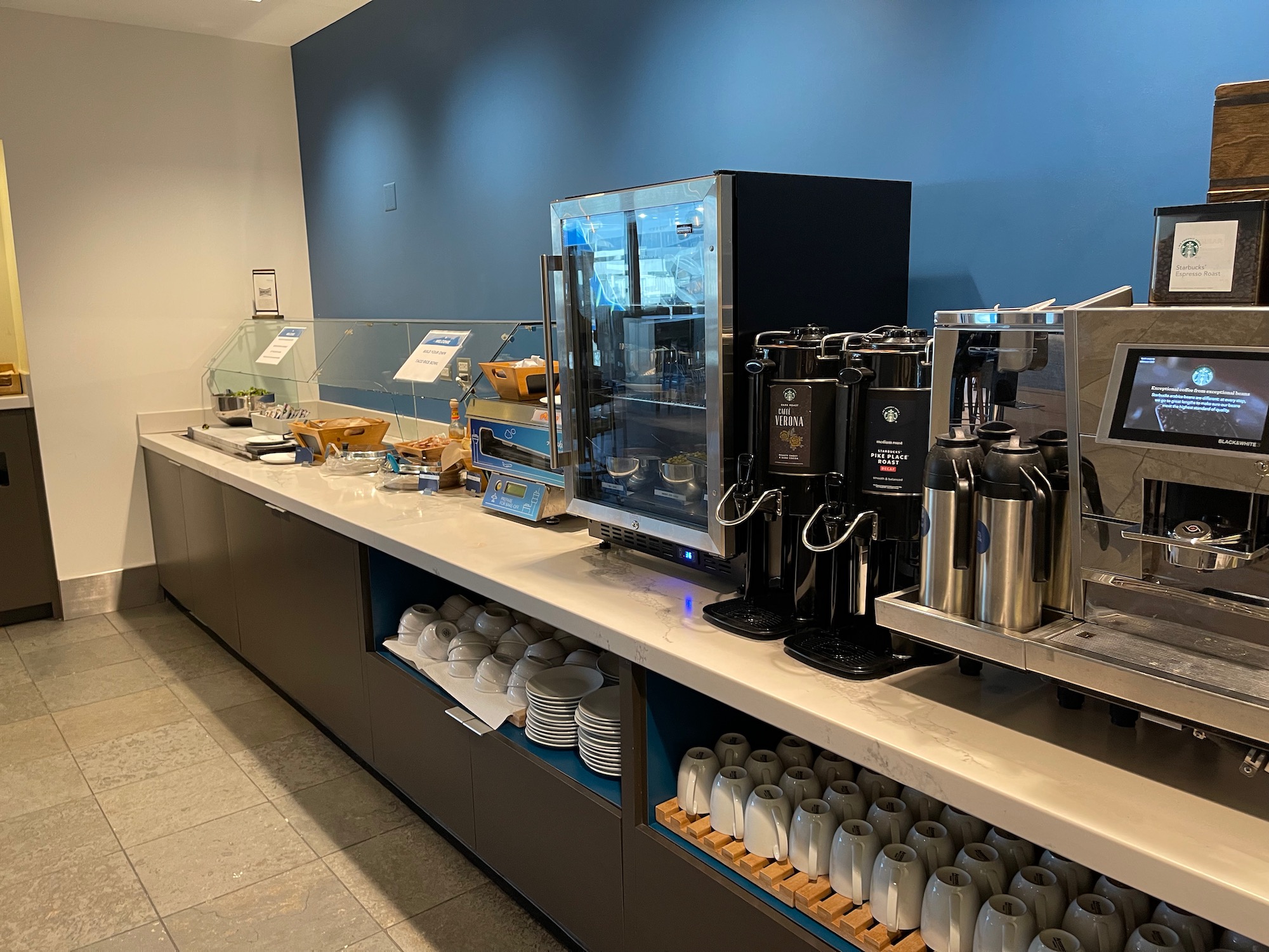 a coffee machine and cups on a counter