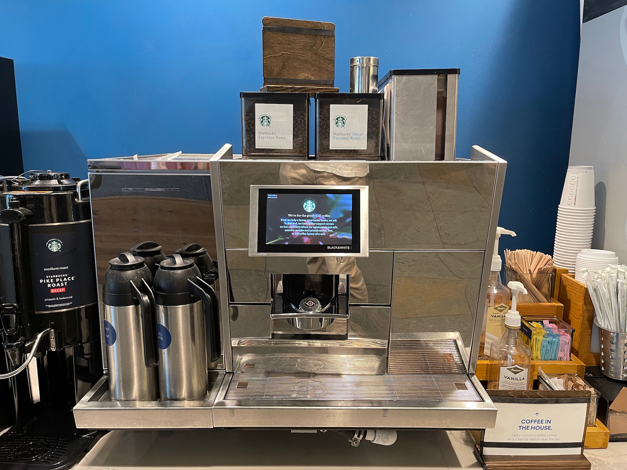 a coffee machine with a screen and other items on top