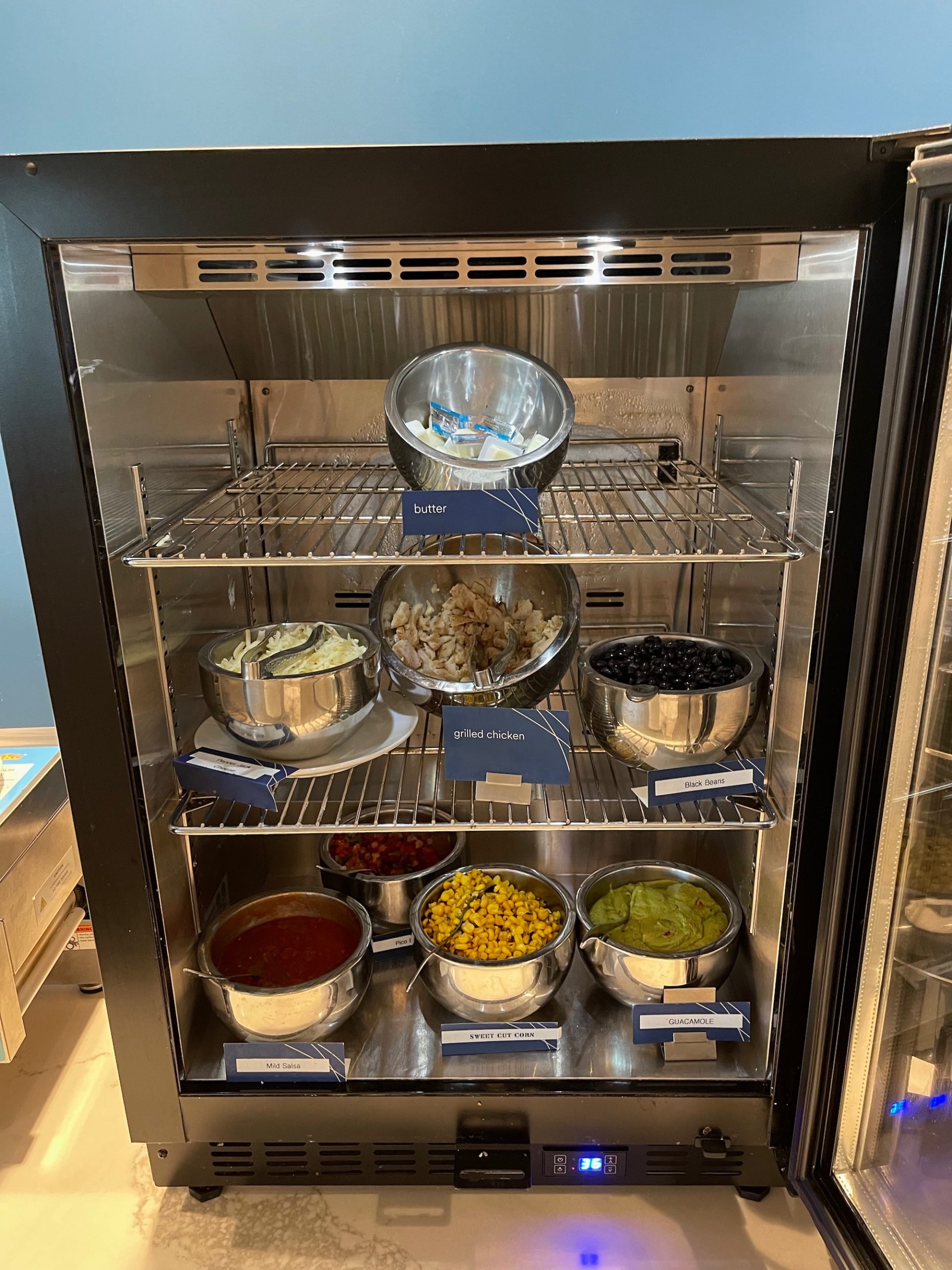 a display case with bowls of food