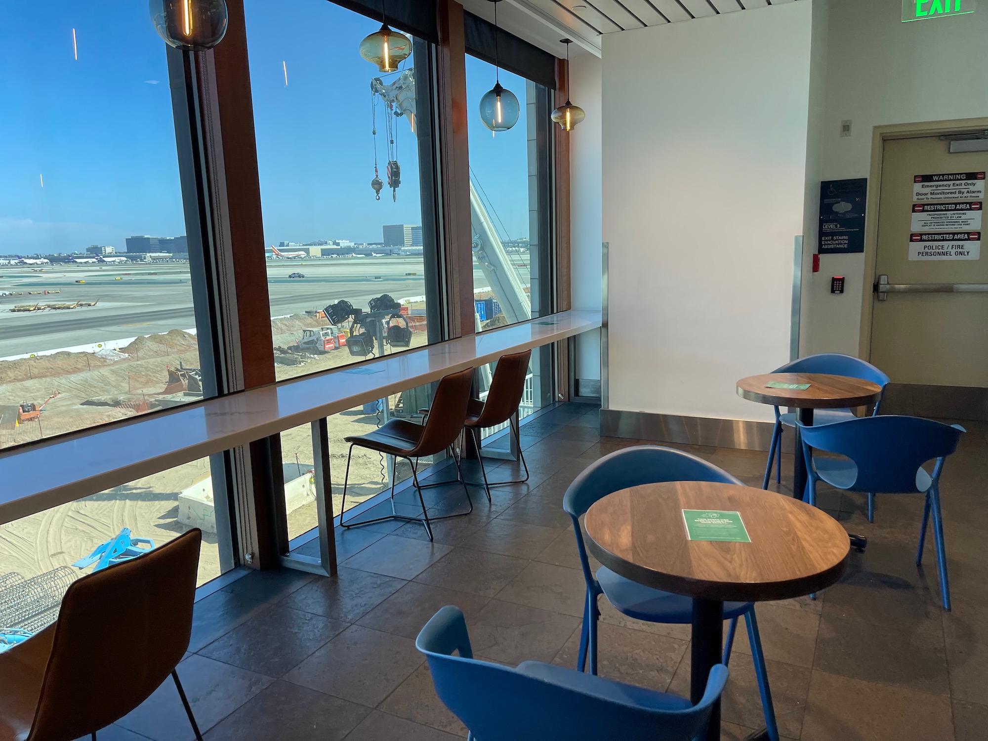 a room with tables and chairs and a window