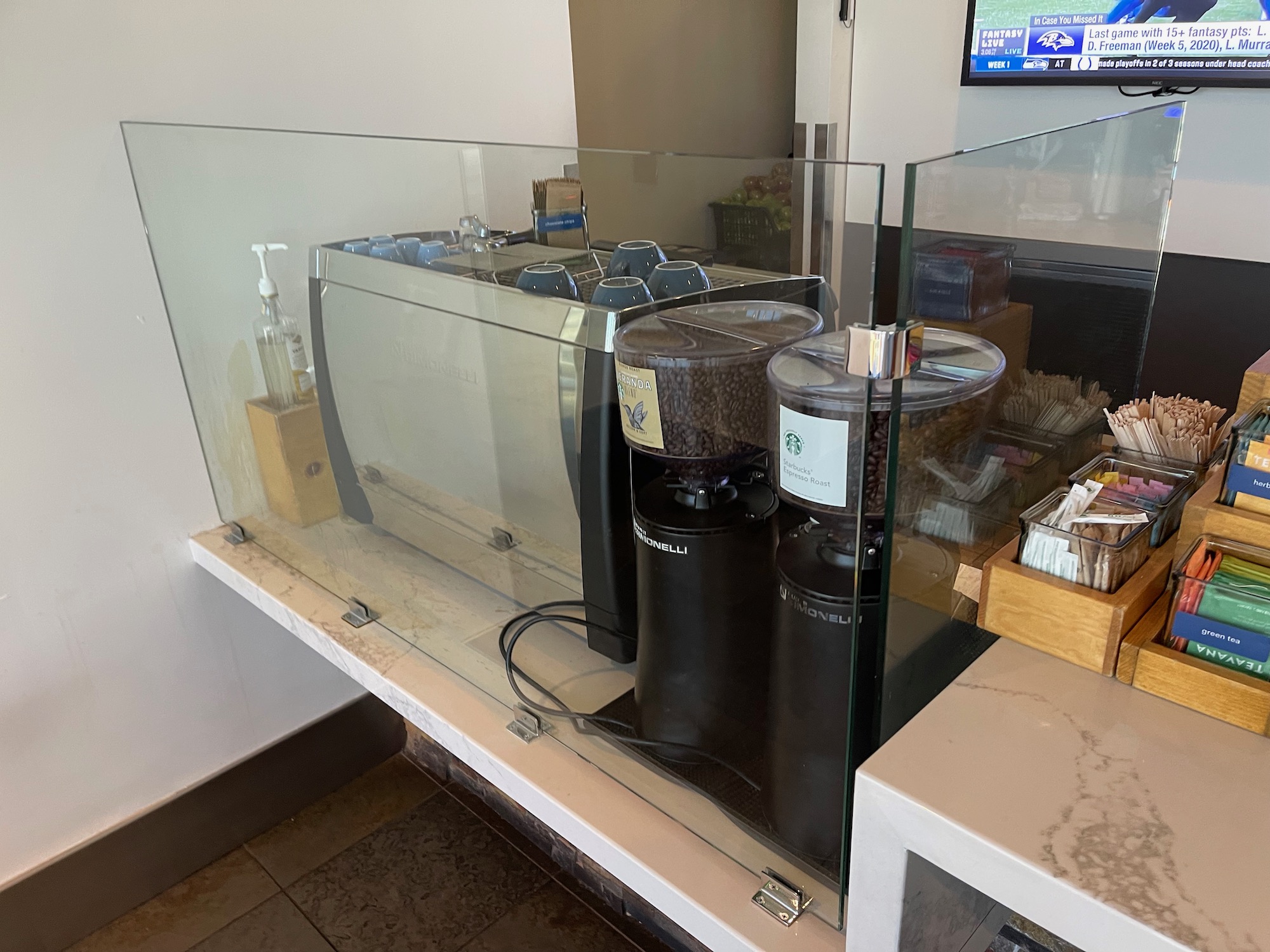 a glass case with a group of coffee machines