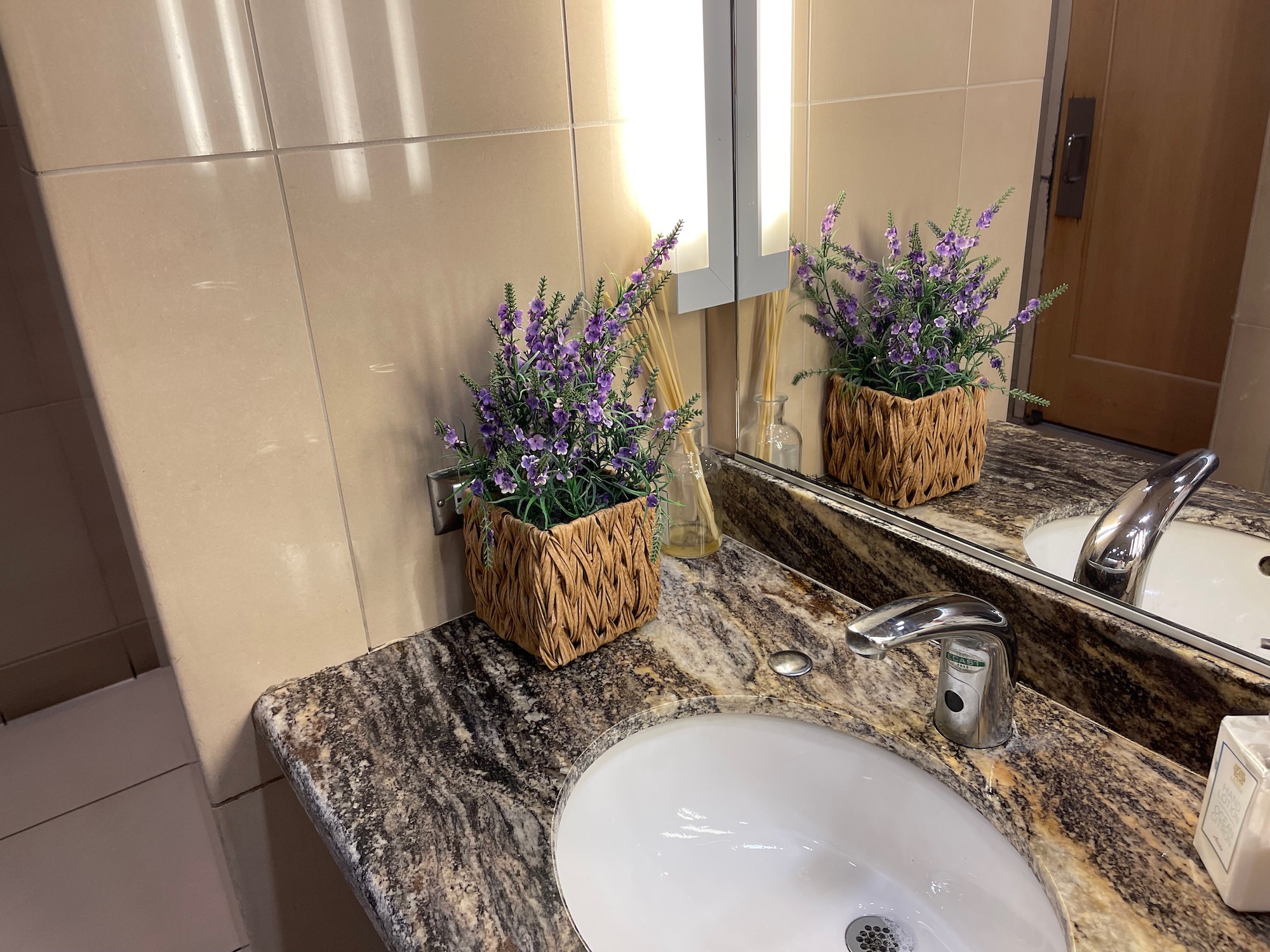 a sink with a plant in a basket