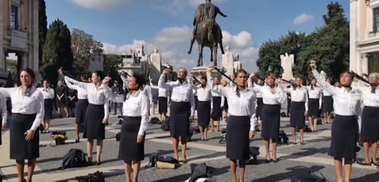 a group of people holding up a statue