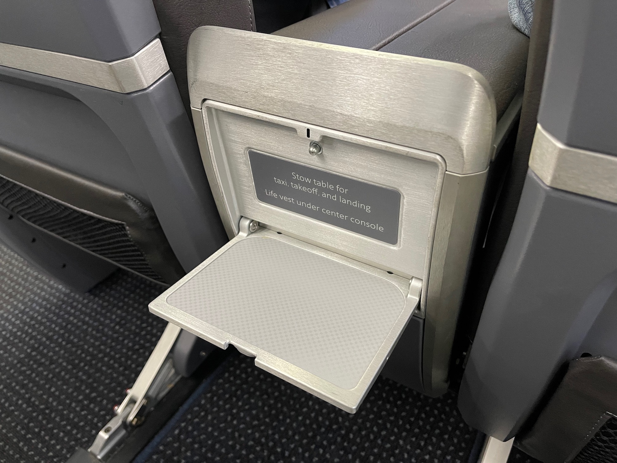 an arm rest with a small shelf