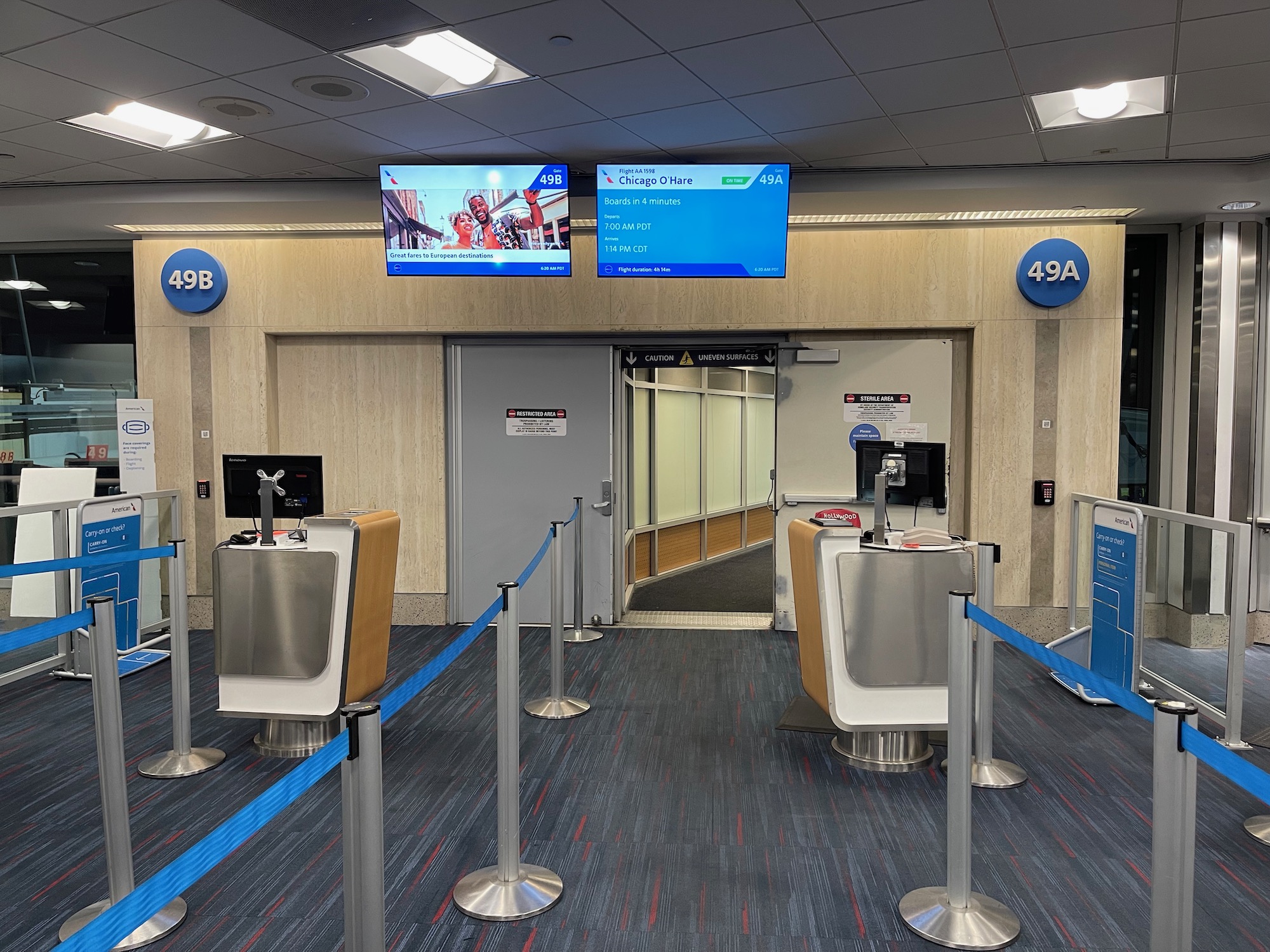 a blue carpeted room with a blue roped line and a blue screen