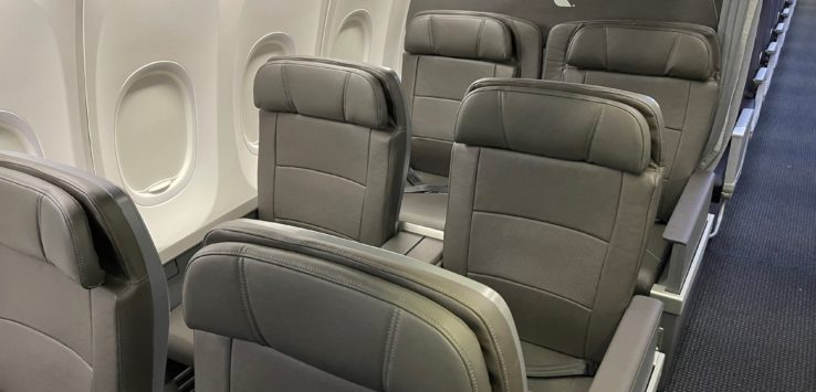 a row of grey seats in an airplane