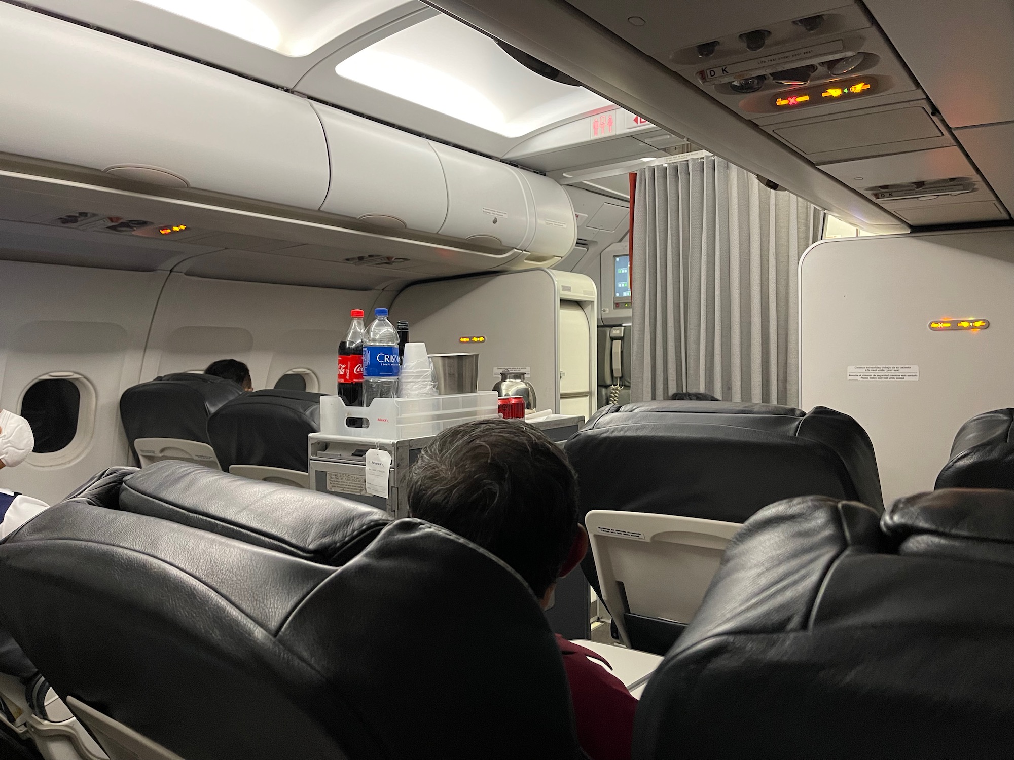 a group of people sitting in chairs in an airplane