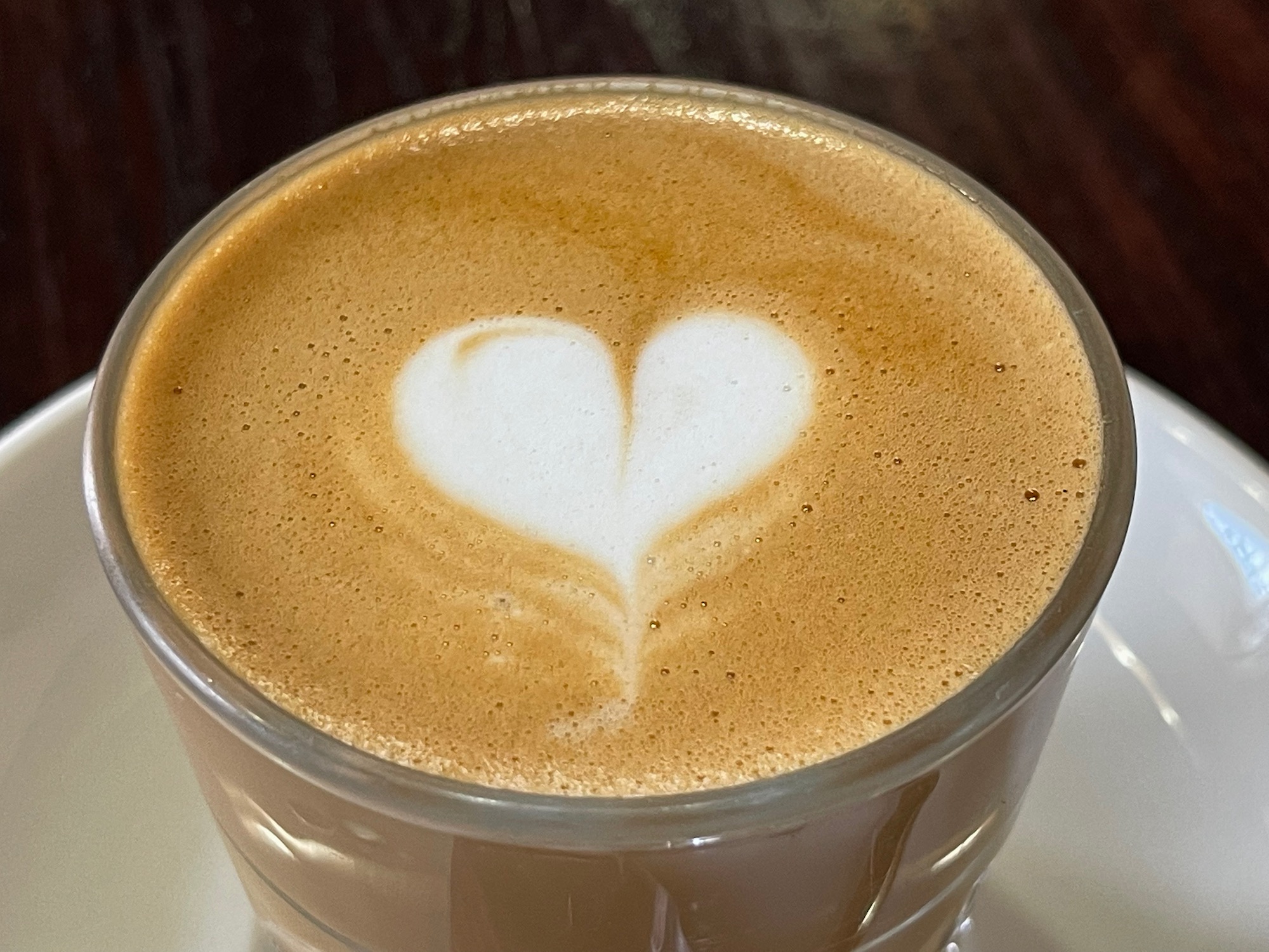 a cup of coffee with a heart in the foam