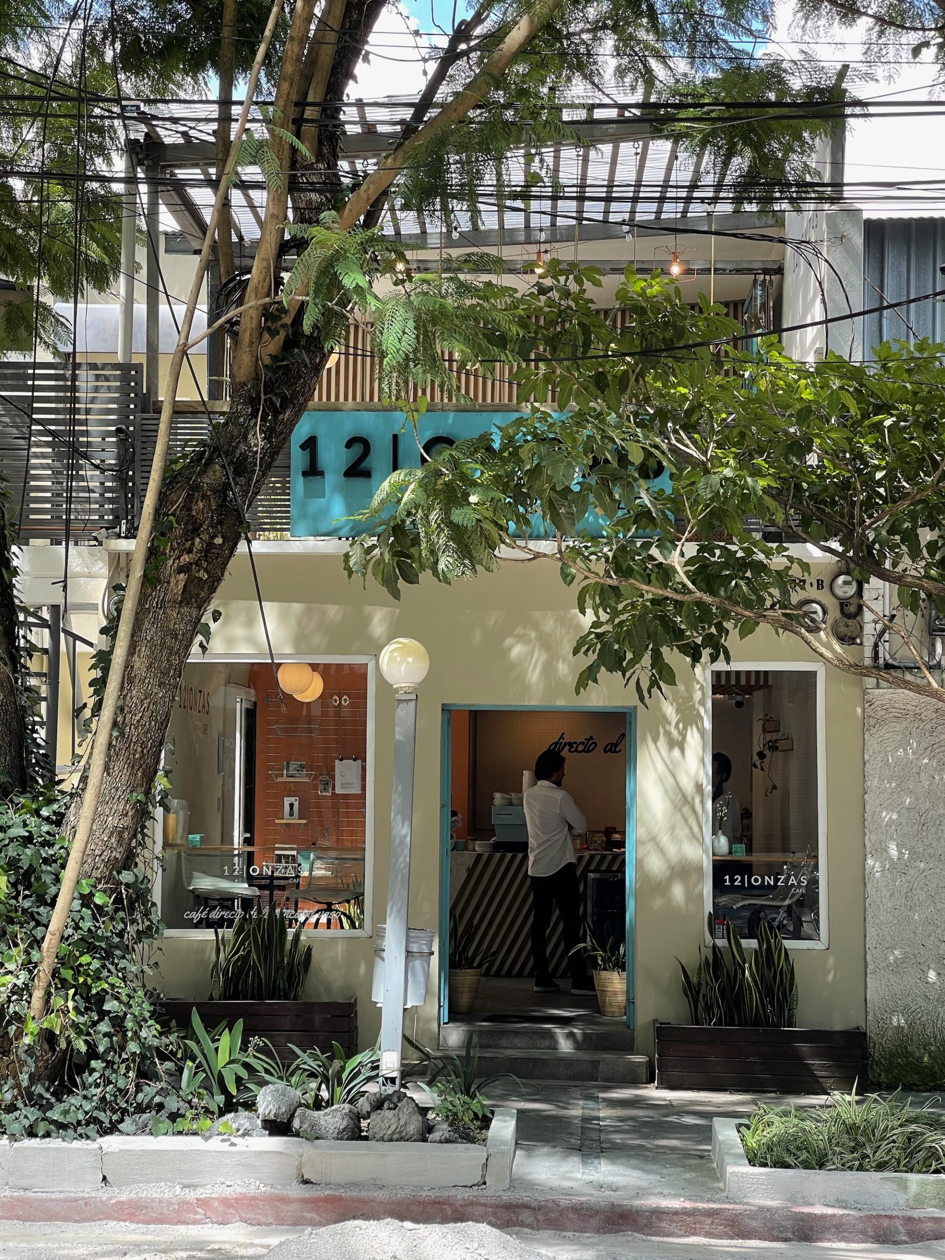 a building with a person standing in the doorway