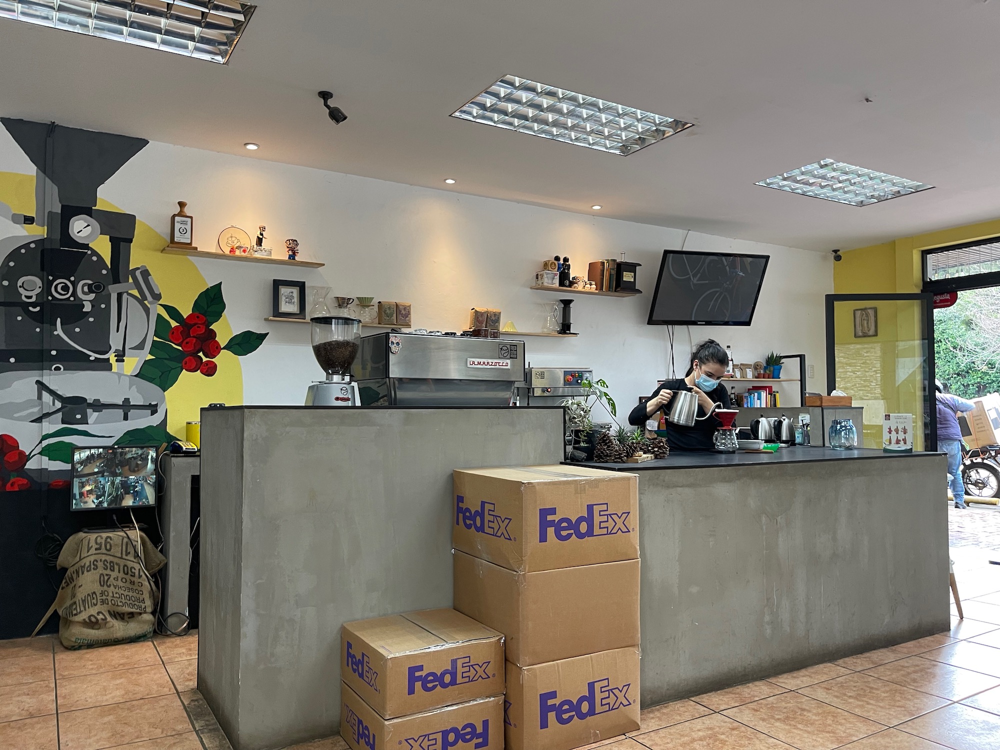 a person standing at a counter in a coffee shop