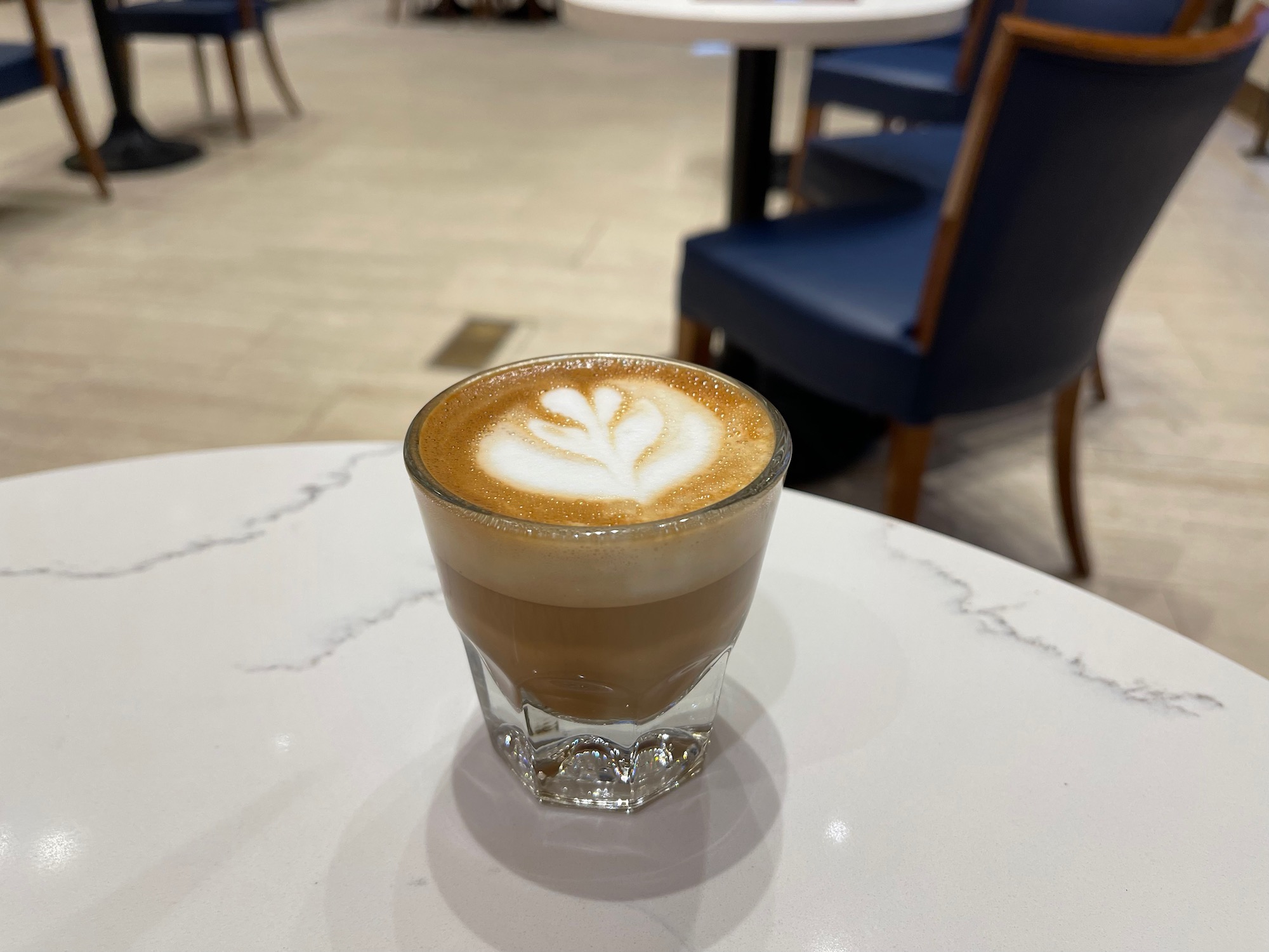 a glass of coffee on a table