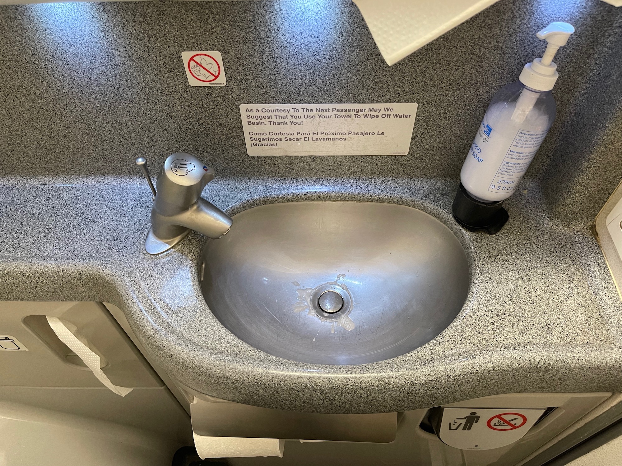 a sink with a sign on the wall