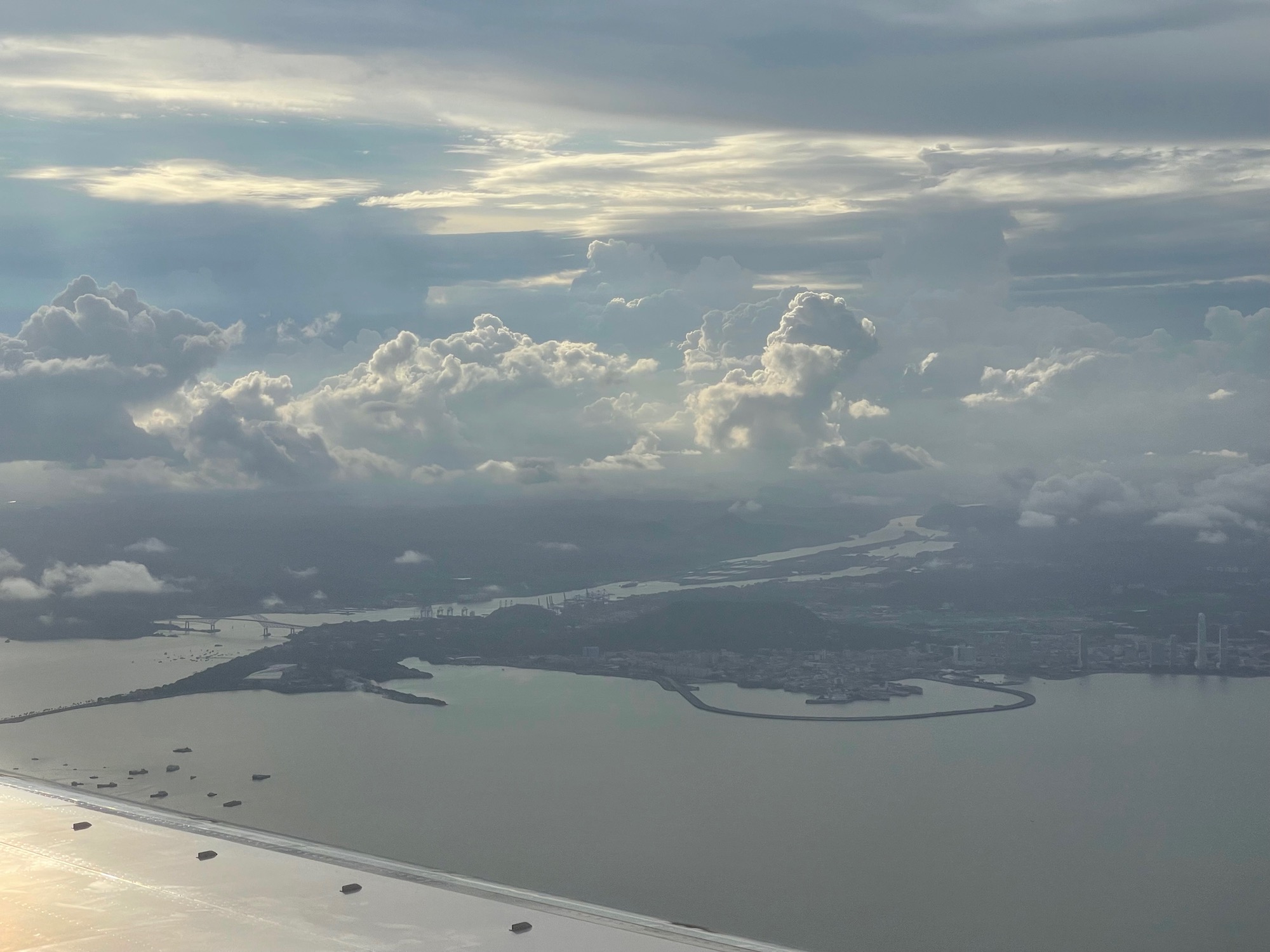 a body of water with buildings and clouds