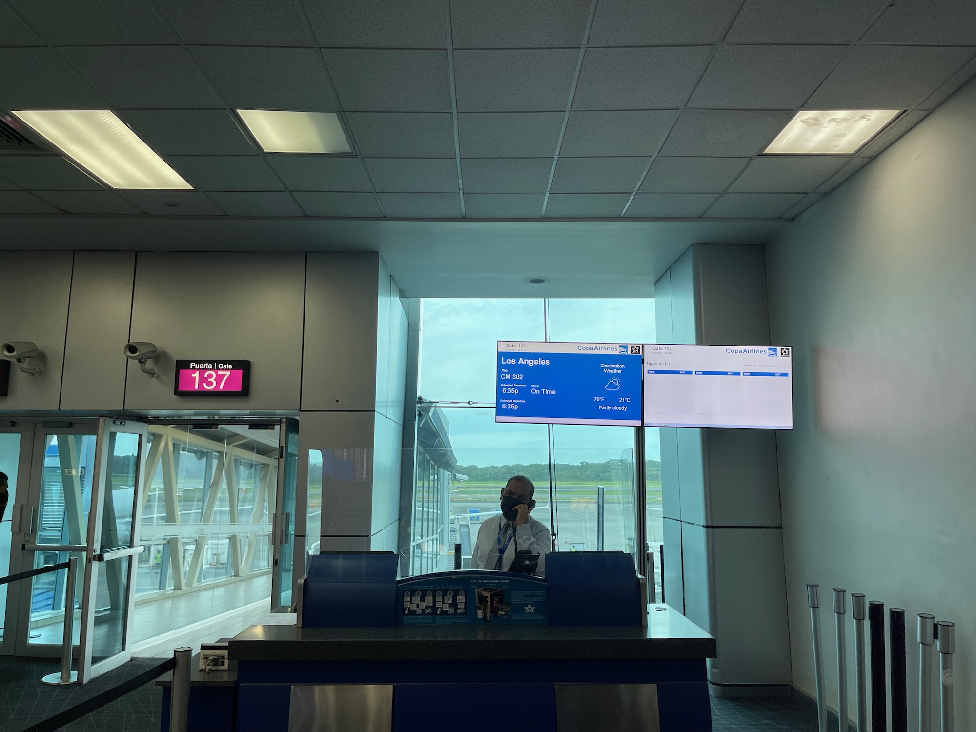 a man standing at a counter in an airport