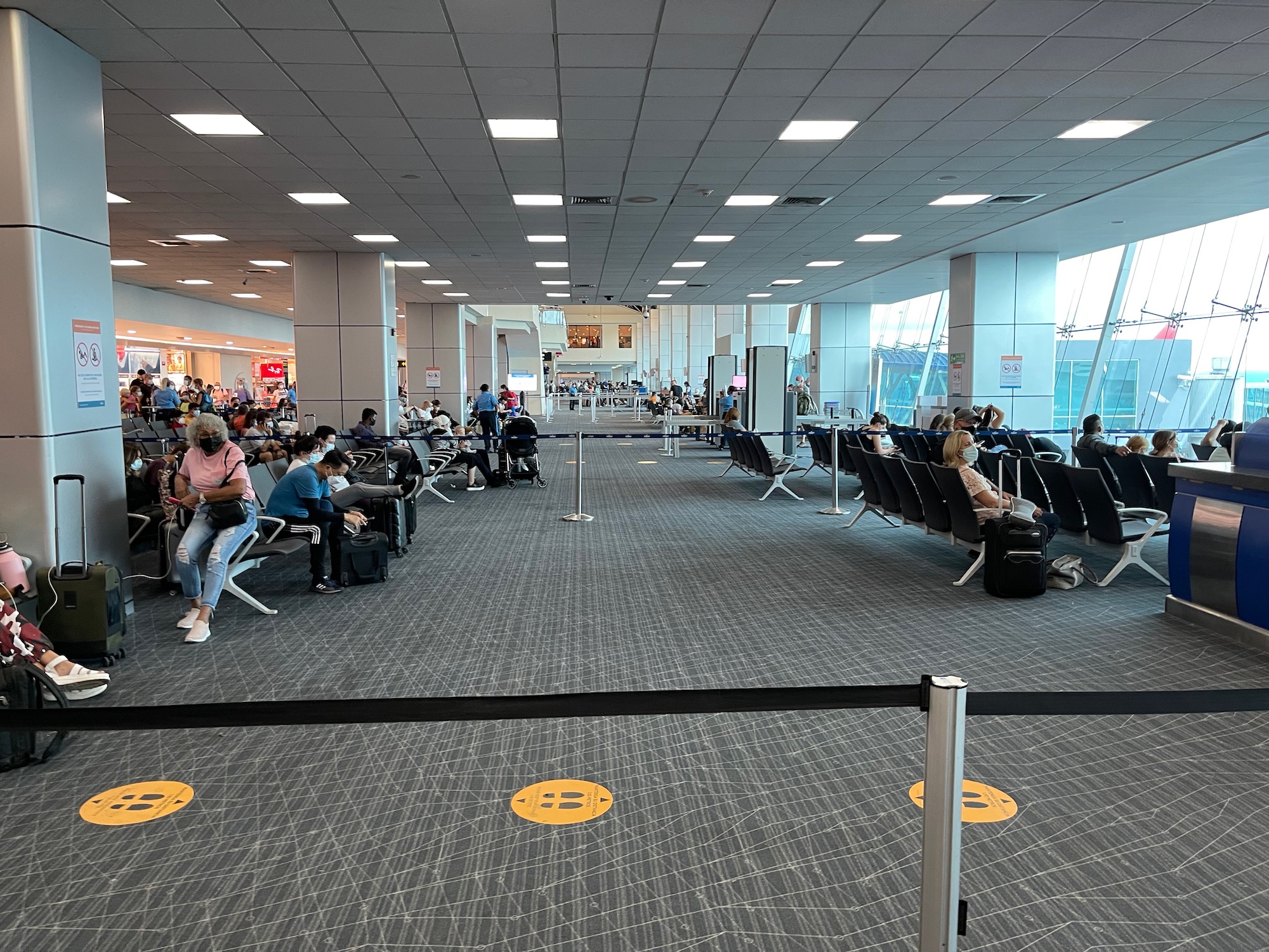 a group of people sitting in chairs in an airport