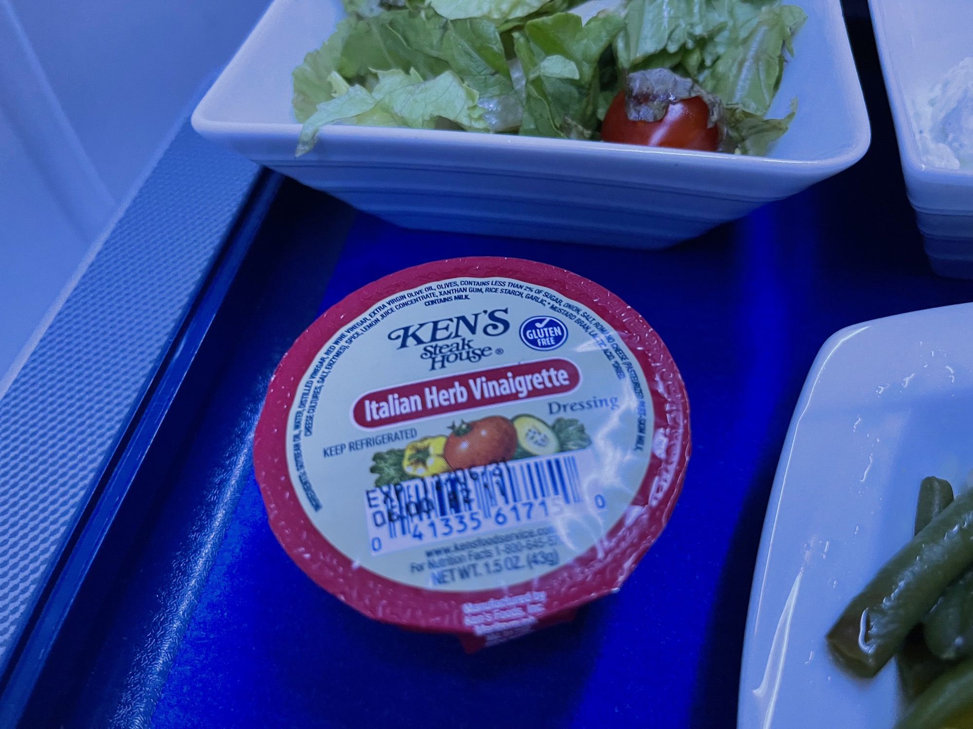 a bowl of salad and a container of cheese