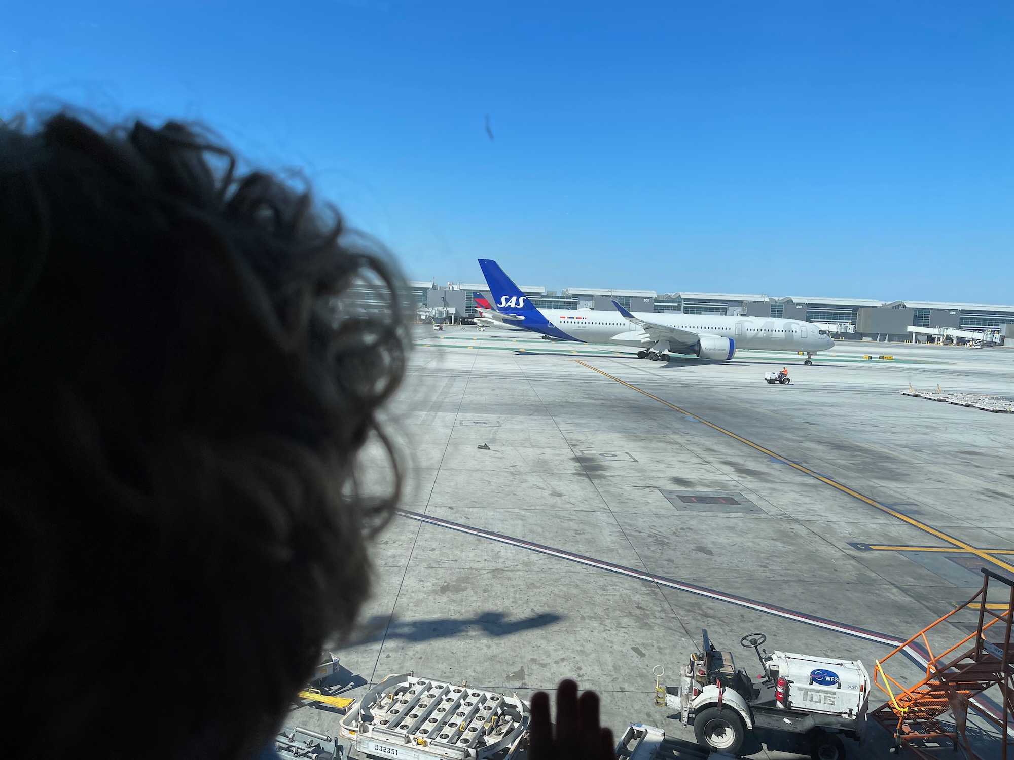 a person looking at airplanes on a runway