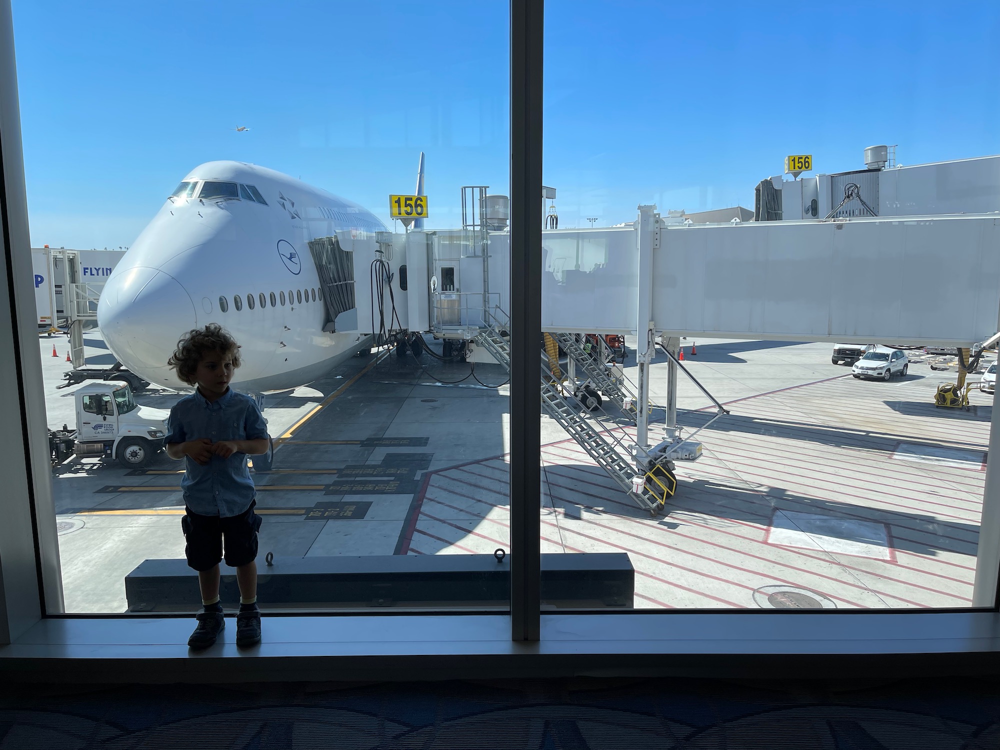 a boy standing in front of a large window