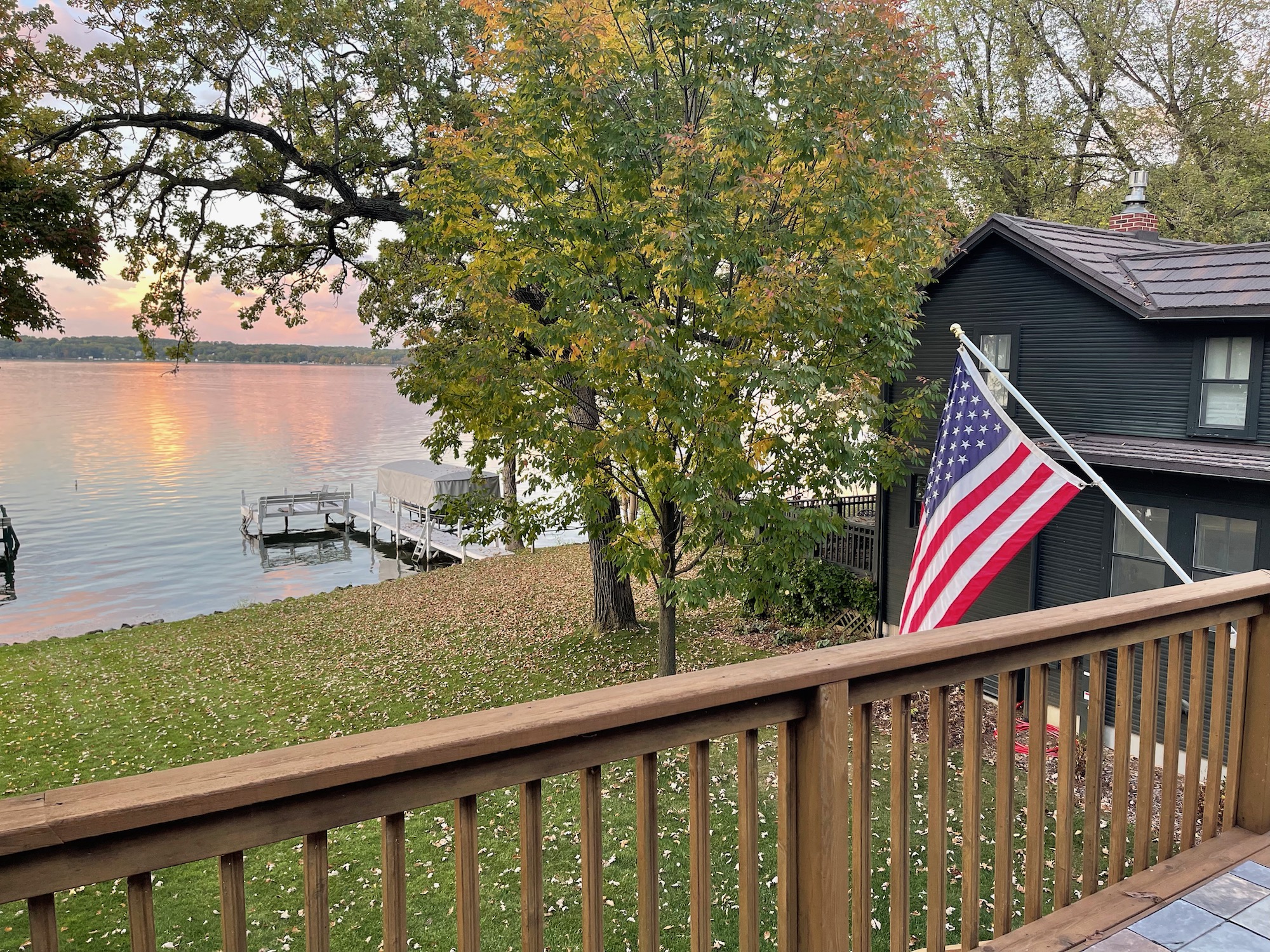a deck with a flag and a lake