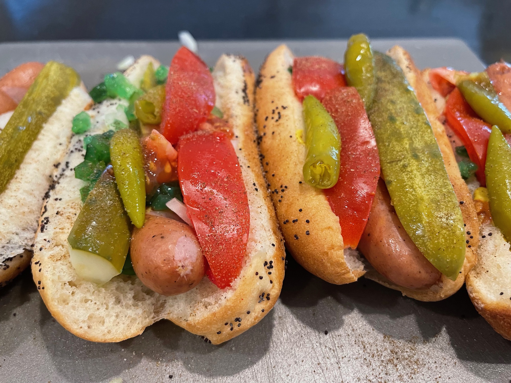 a group of hot dogs with vegetables