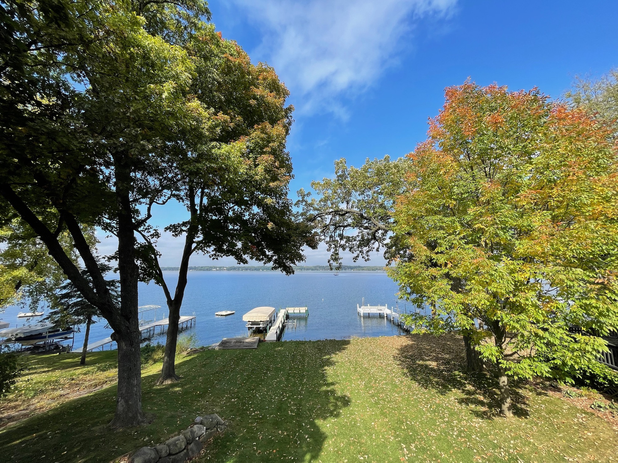 a lake with trees and a dock