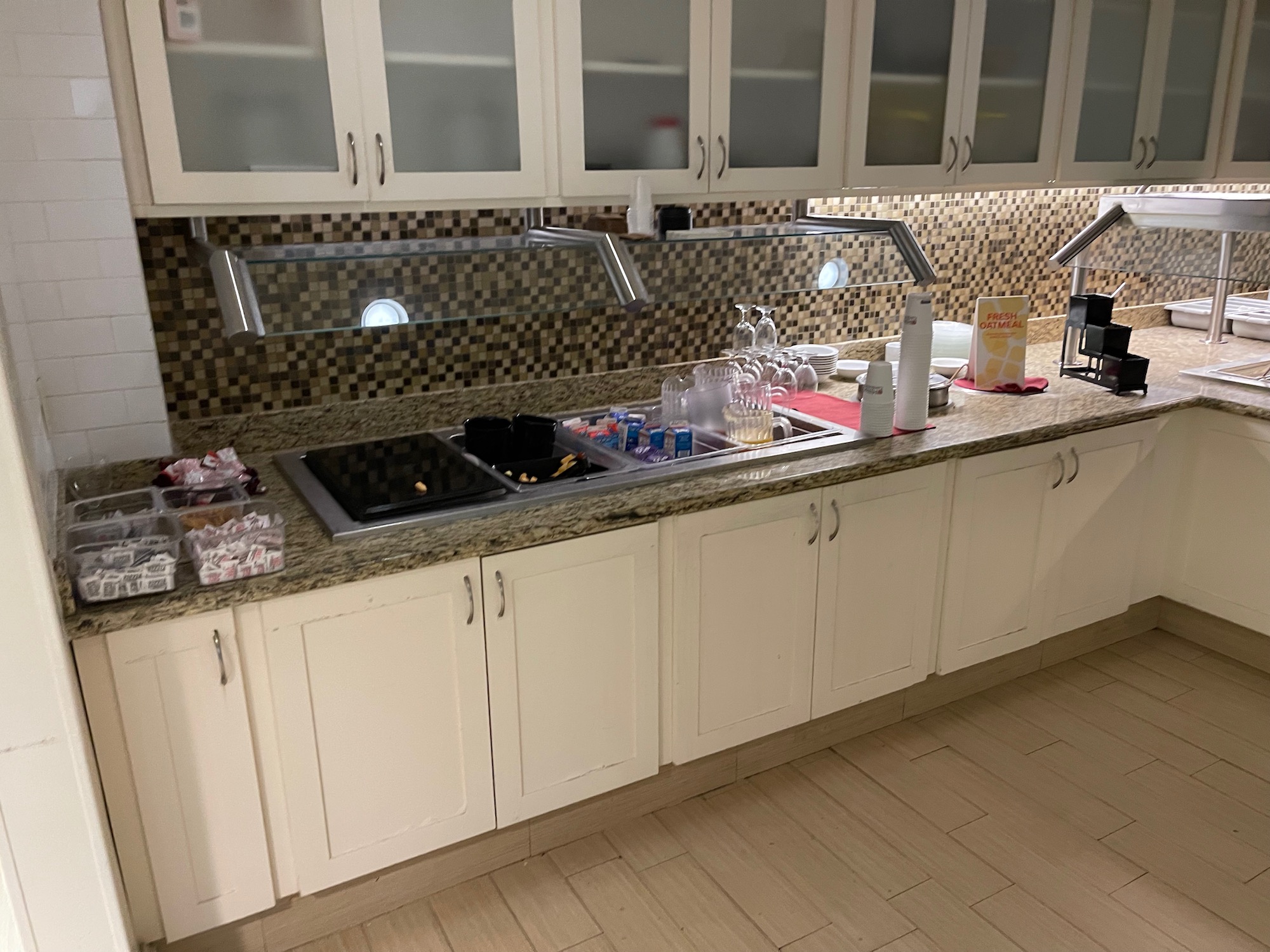 a kitchen with white cabinets and white counter tops