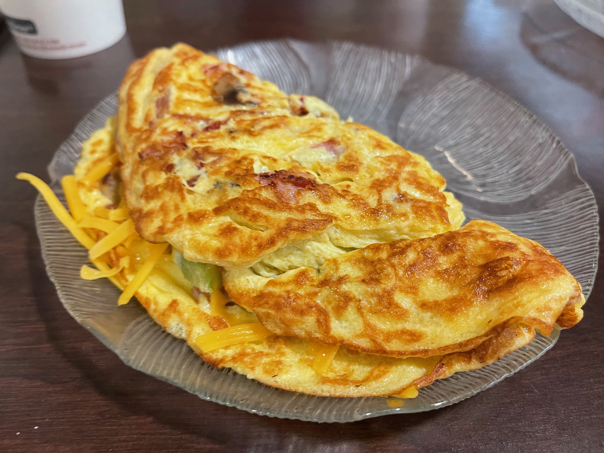 a plate of omelette on a wood table