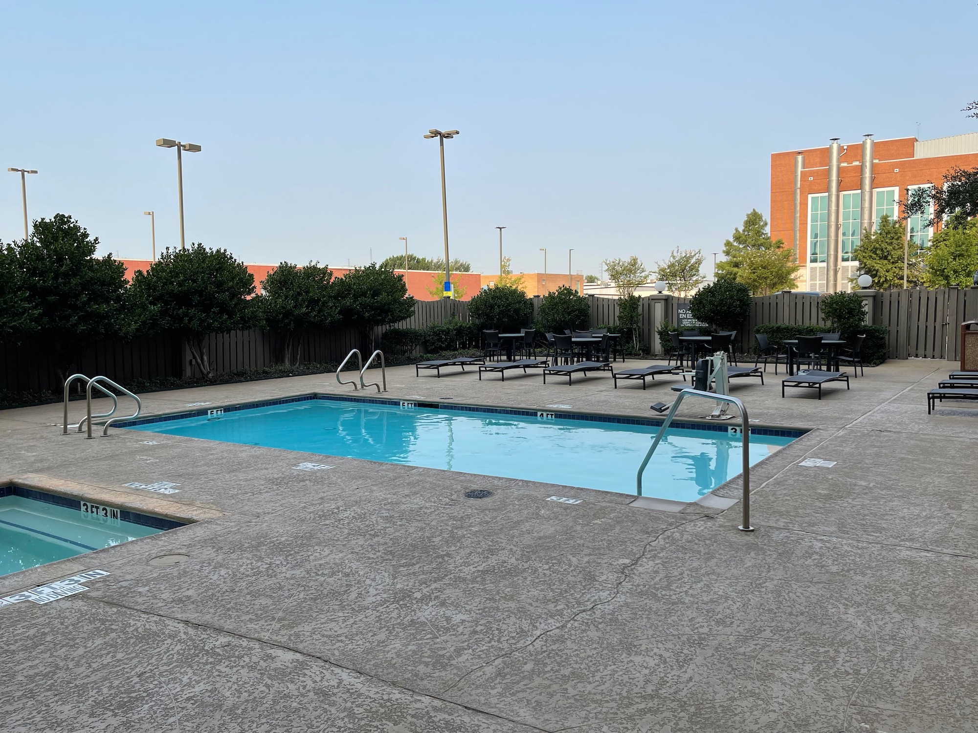 a pool with chairs and tables in a building