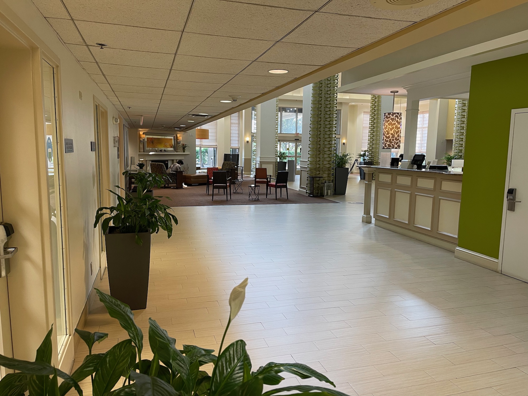 a lobby with a reception desk and plants