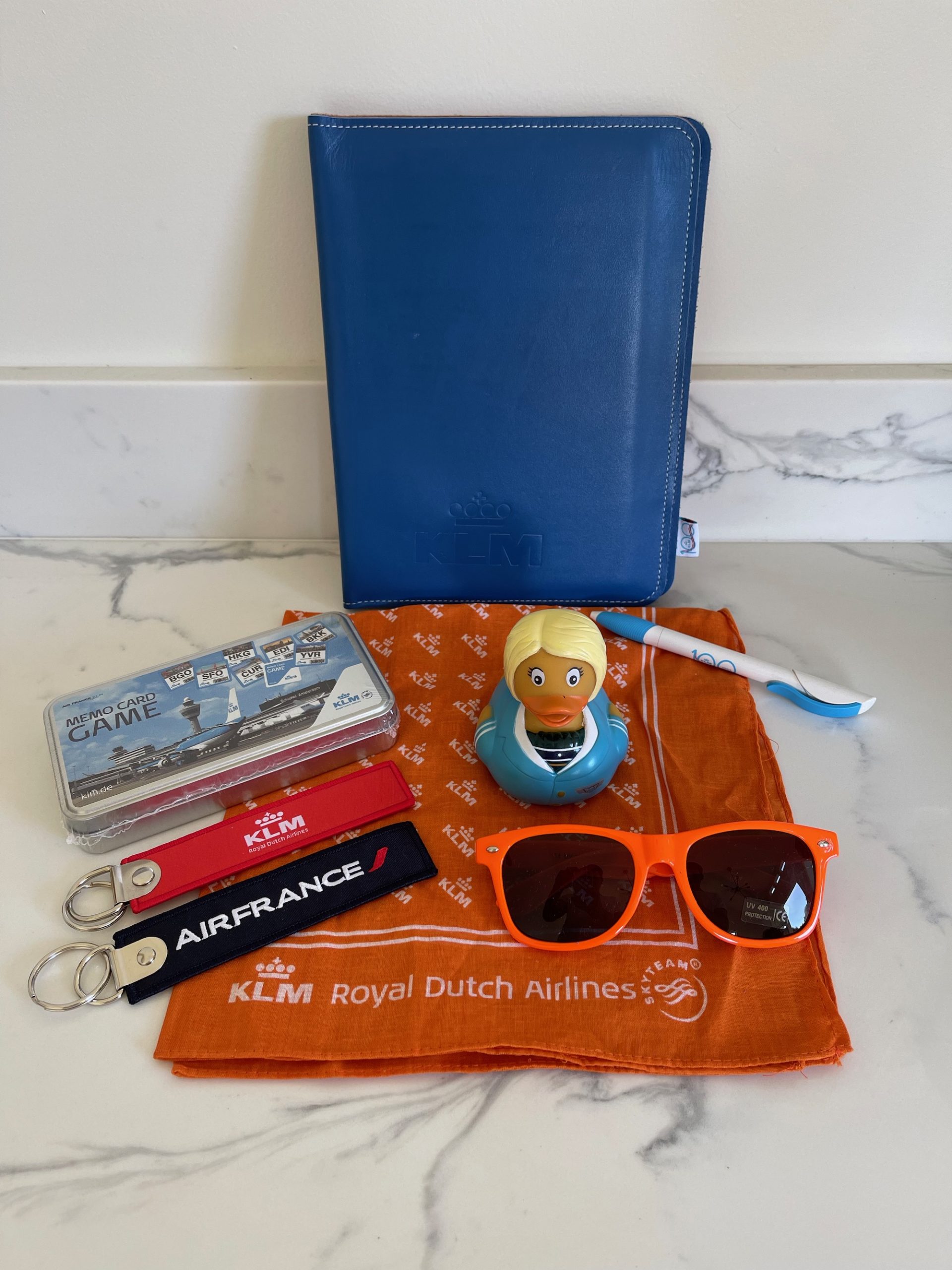 a blue wallet with a rubber duck and sunglasses on it