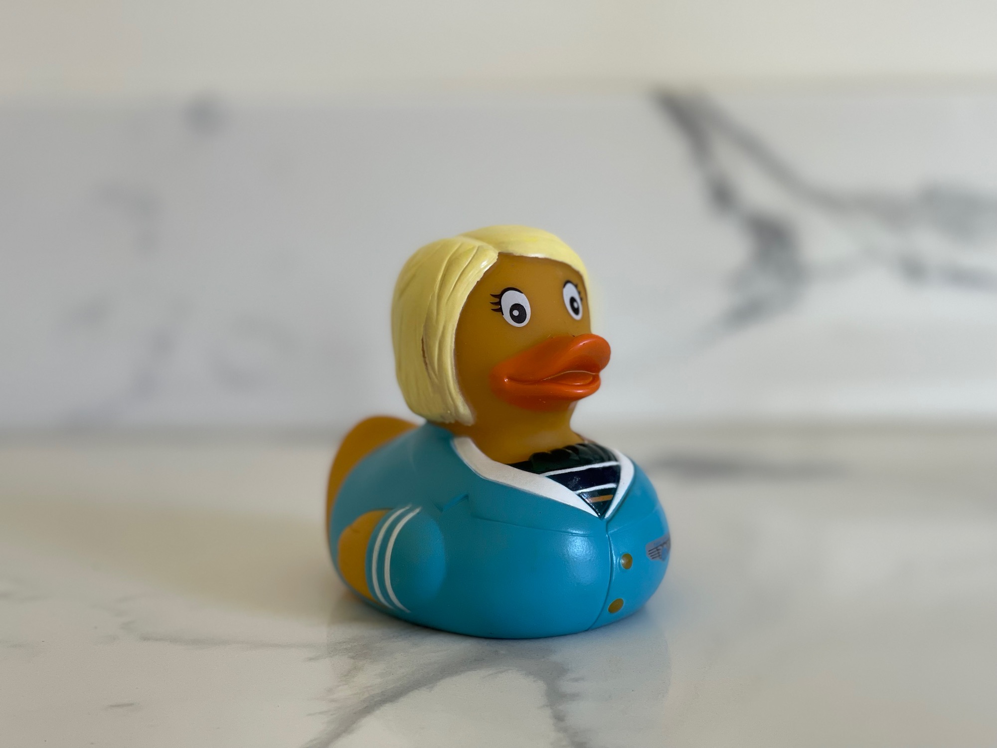 a yellow rubber duck with blonde hair