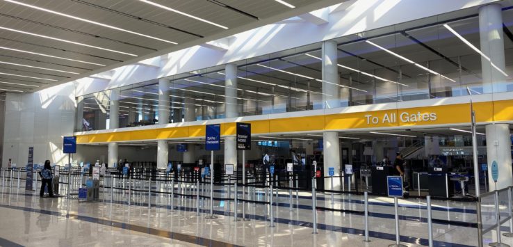 a large airport terminal with people walking around