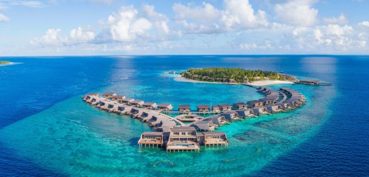 a group of houses on a small island in the ocean