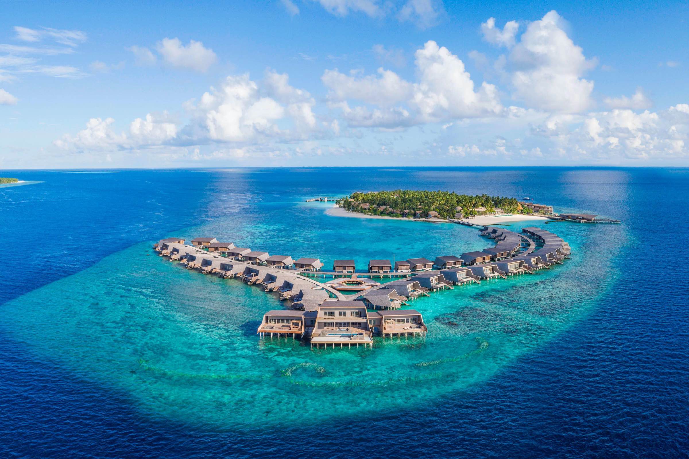 a group of houses on a small island in the ocean