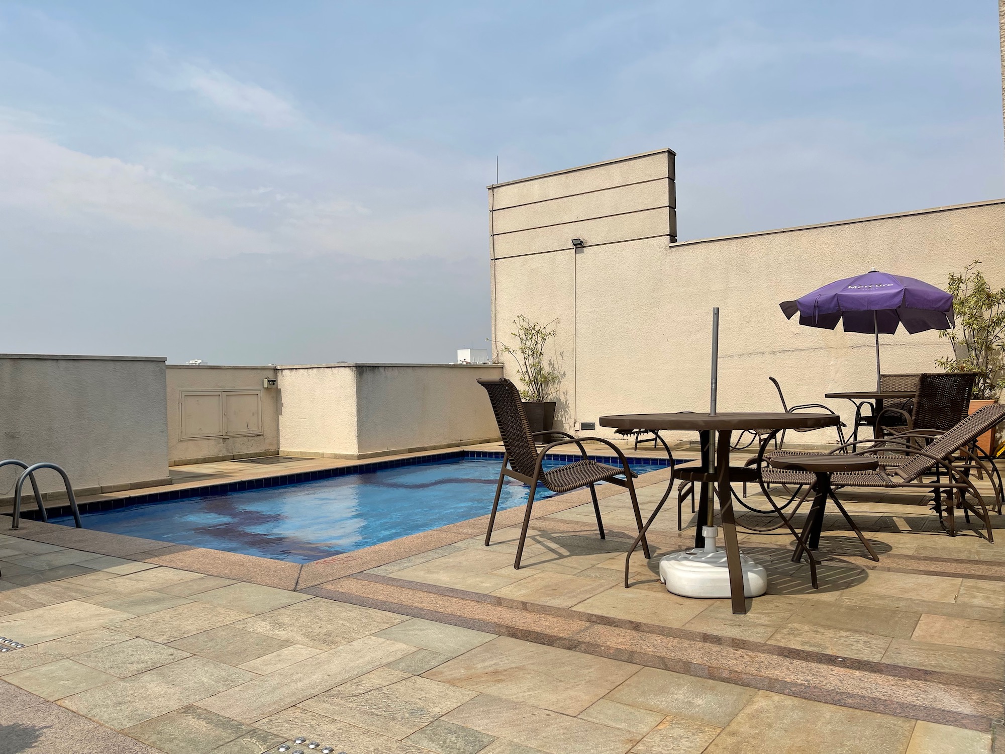 a patio with a pool and table