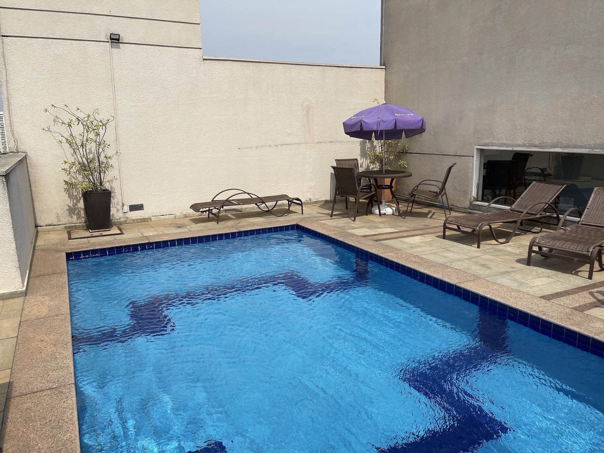 a pool with chairs and umbrella