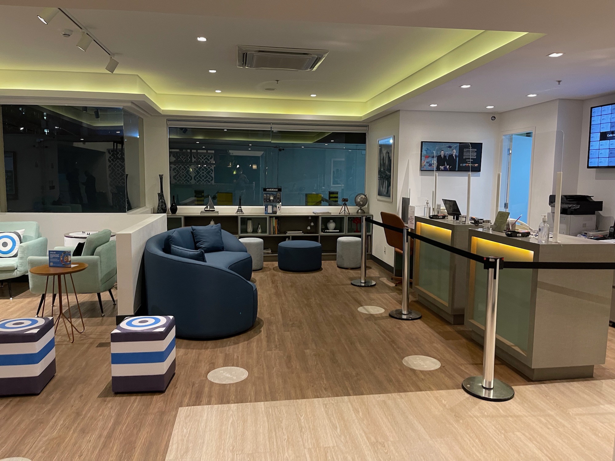 a room with a reception desk and chairs