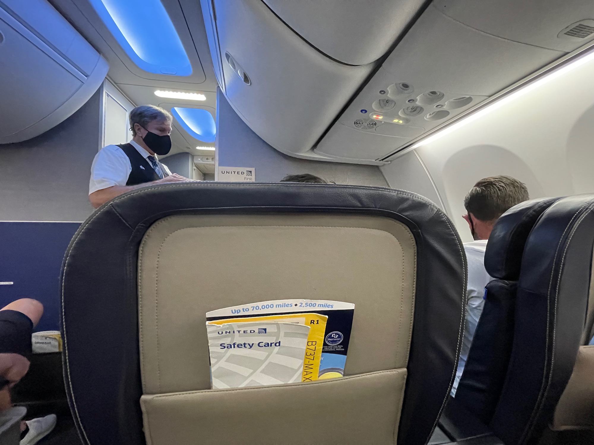 a man wearing a mask on an airplane