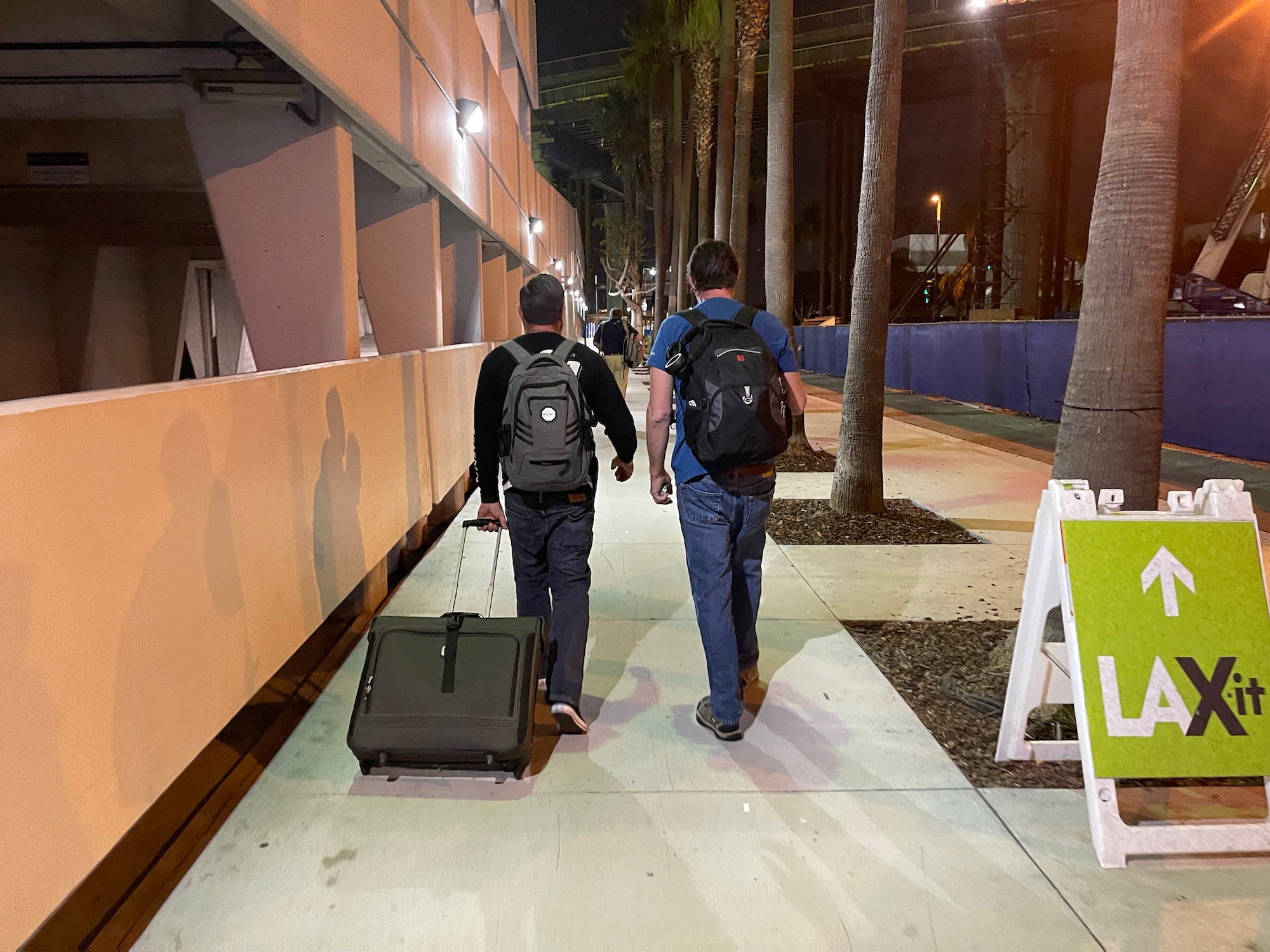 two men walking with luggage