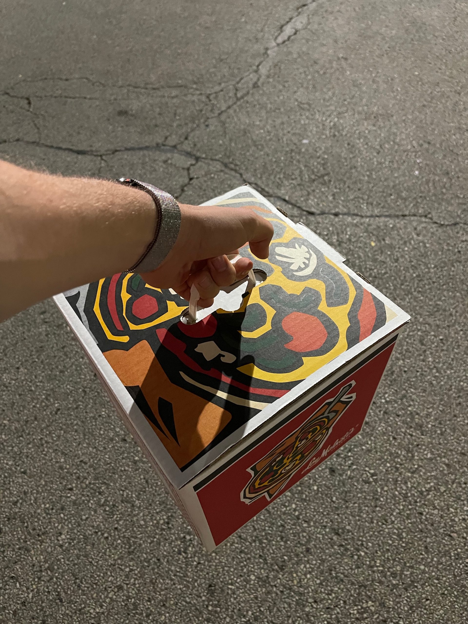 a hand holding a box with a cigarette